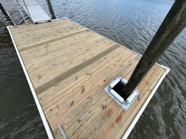 Floating dock with a pile hoop
