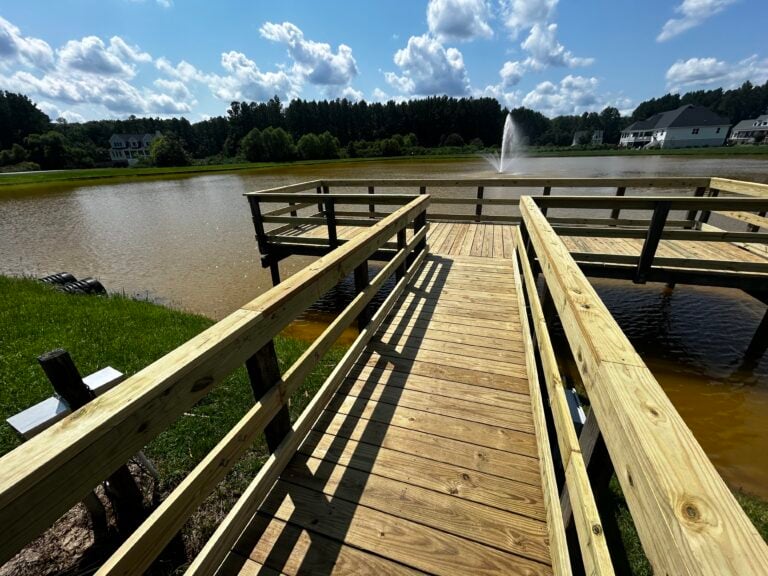 Pond pier with double handrails and a fountain