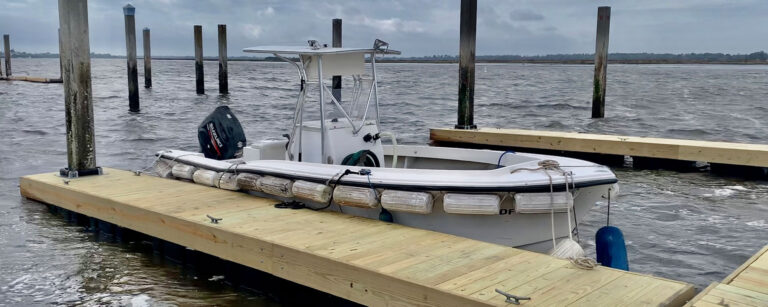 Center console boat tied to a new floating dock