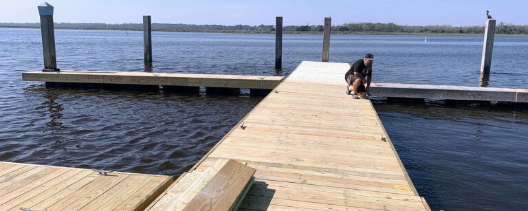 Crew member on a new floating dock on a Charleston river