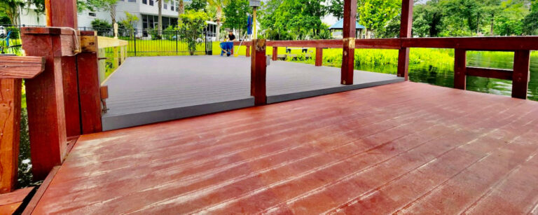 Stained wood deck with red railings