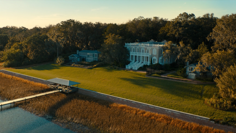 Lowcountry waterfront home in Charleston with a seawall and a private dock over the marsh
