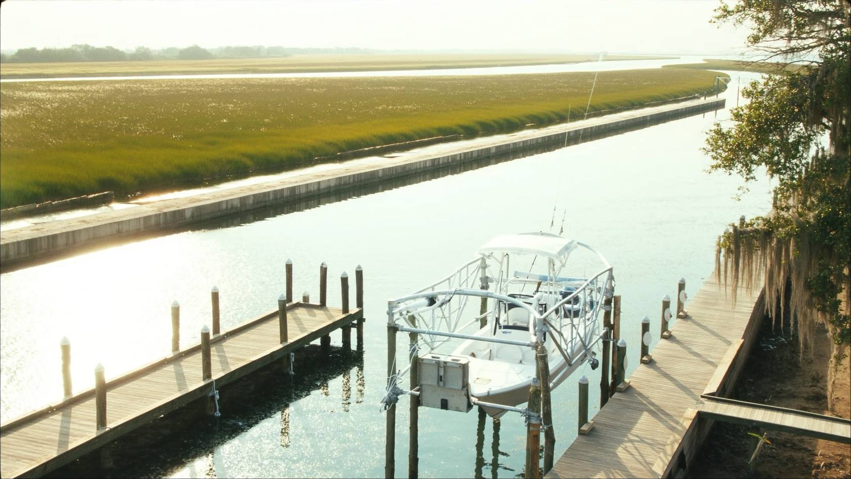 Four-post boat lift holding a center console boat on a Charleston creek