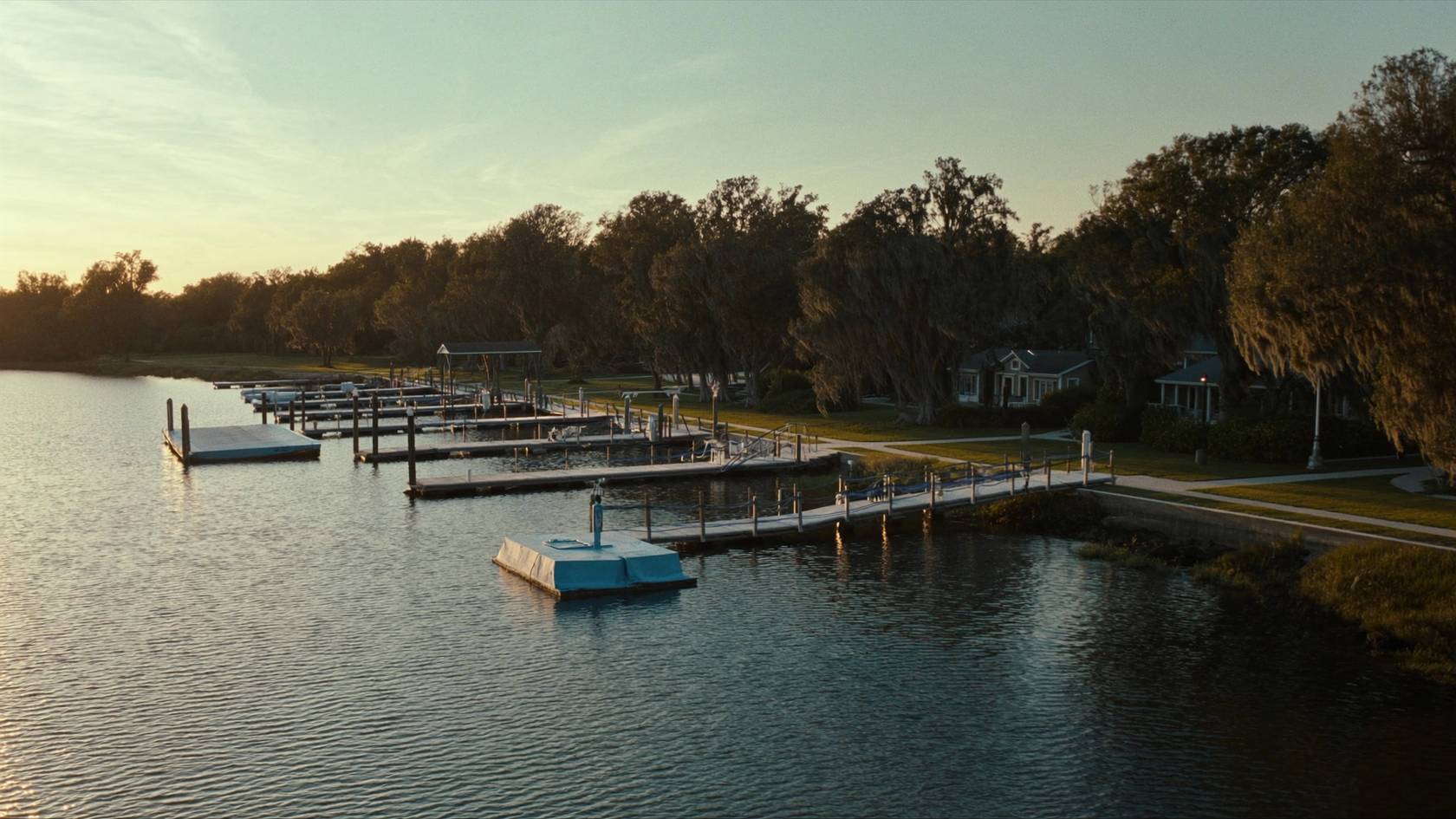 Shared community dock with multiple boat slips on a Charleston river