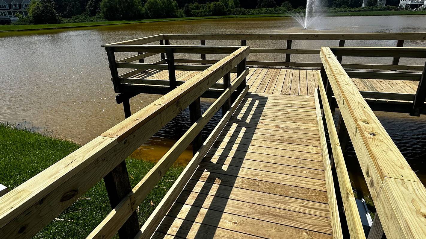 New elevated pier with double handrails over a Lowcountry pond